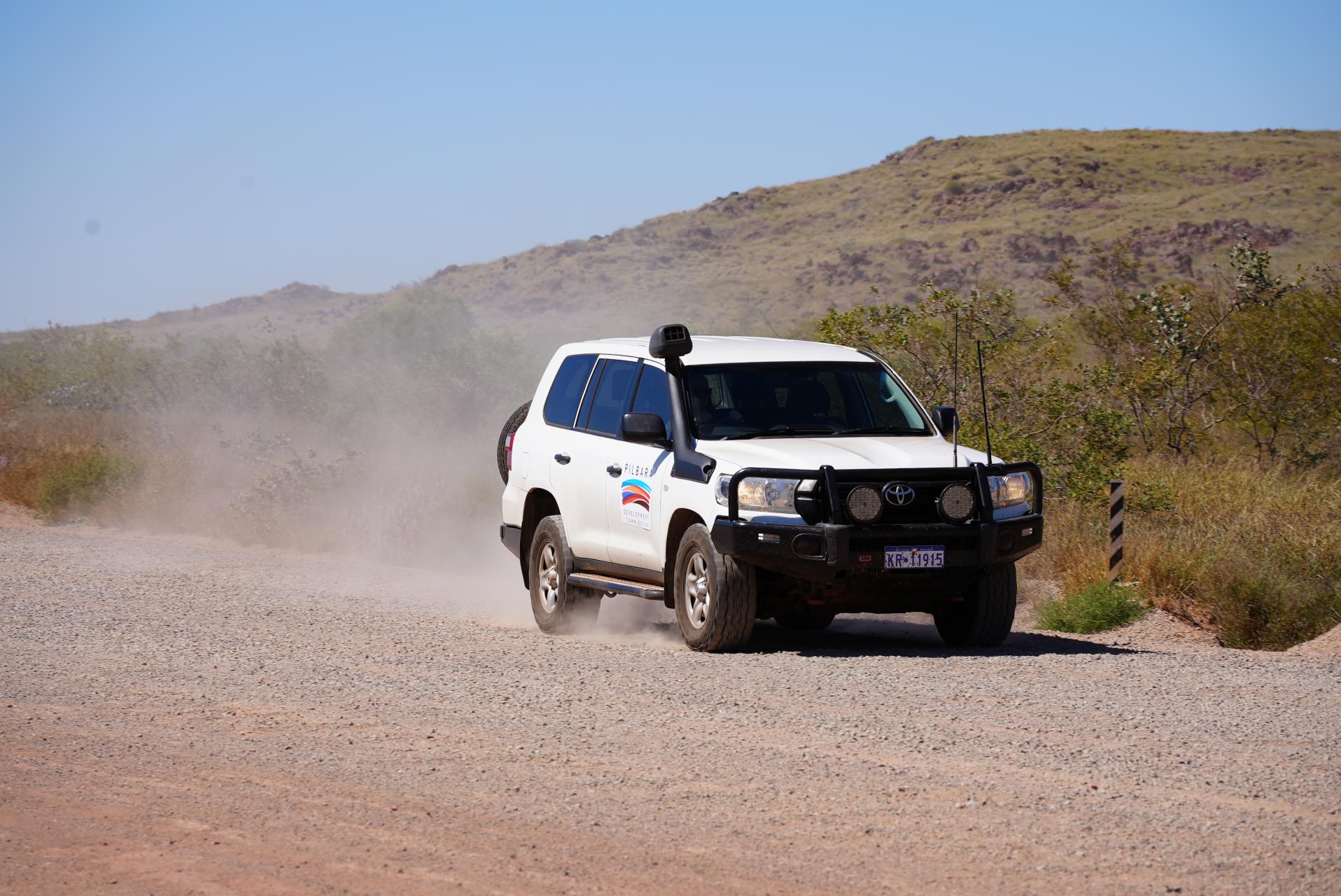 A Pilbara Development Commission vehicle travelling in the Pilbara